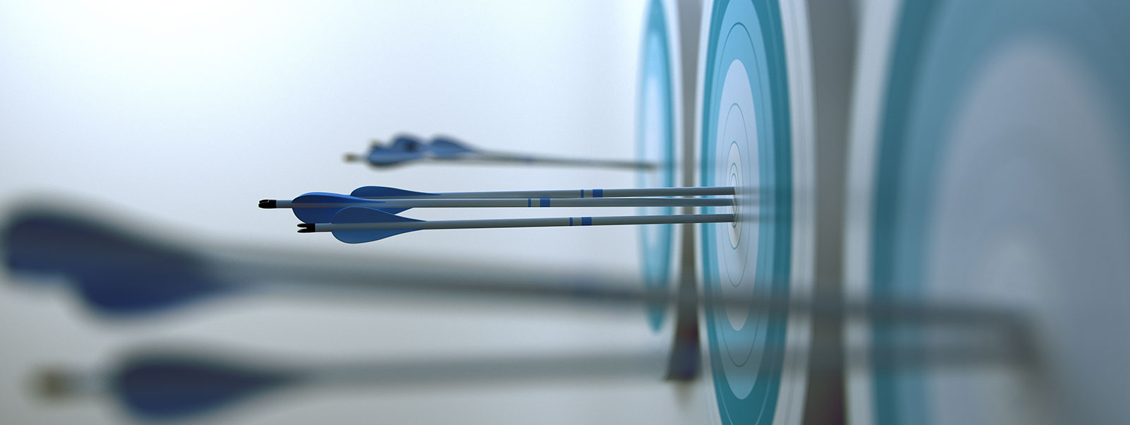 Close up photography of darts that hit the middle of a target.